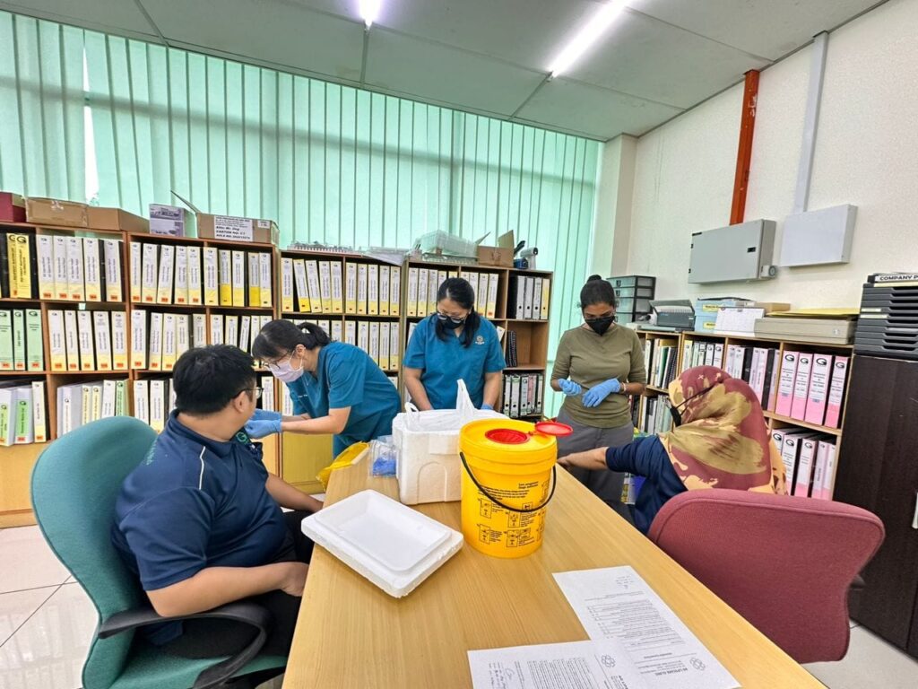 AG Lifecare Clinic staff conducting corporate onsite health screening at a company office